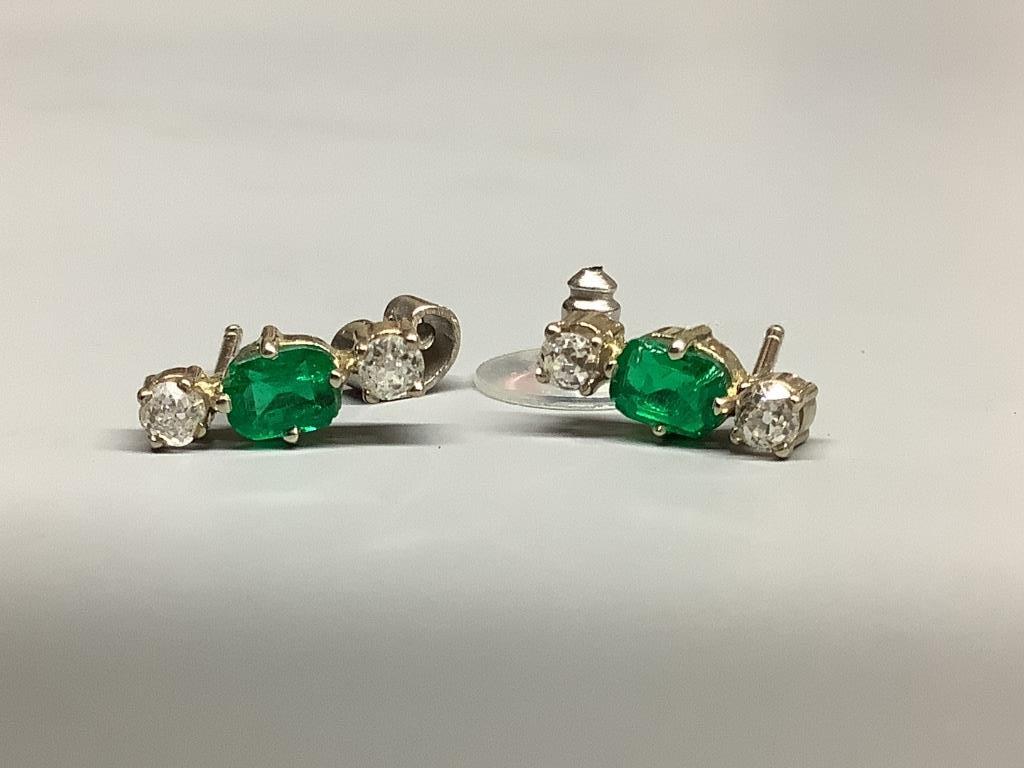A modern pair of white metal, emerald and diamond set ear studs, 13mm, gross weight 2.6 grams.